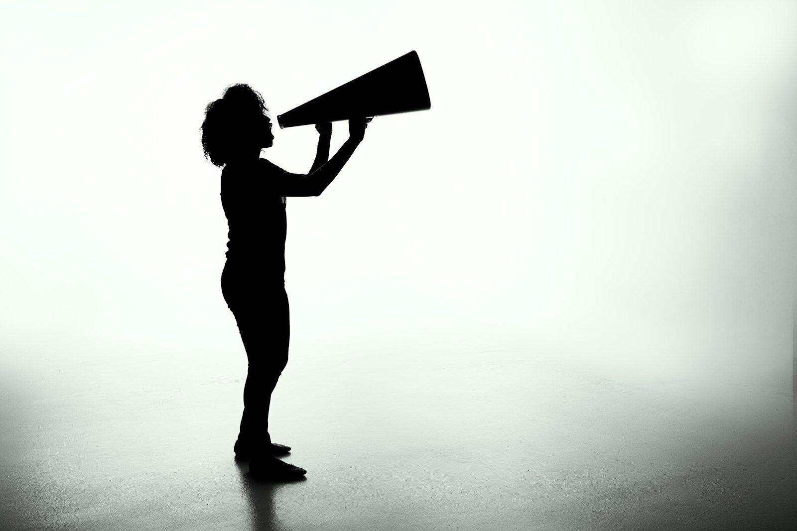 Photo by Patrick Fore silhouette of woman holding rectangular board